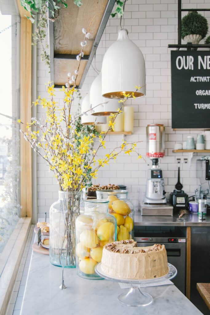 baked cake near lemon fruits in glass container in a kitchen, kitchen countertop decor ideas