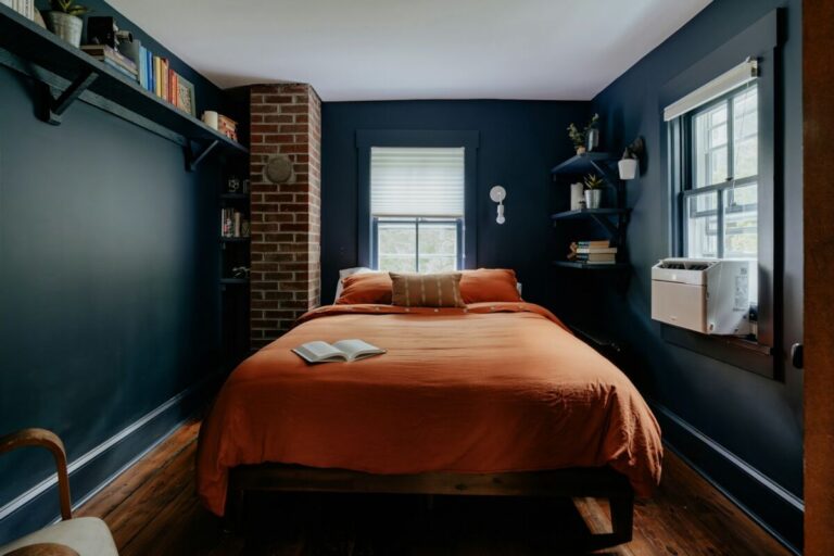 A bed sitting in a bedroom next to a window, Dark Blue Bedroom Ideas