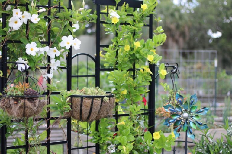 a table with flowers and chairs, Garden Trellis Ideas