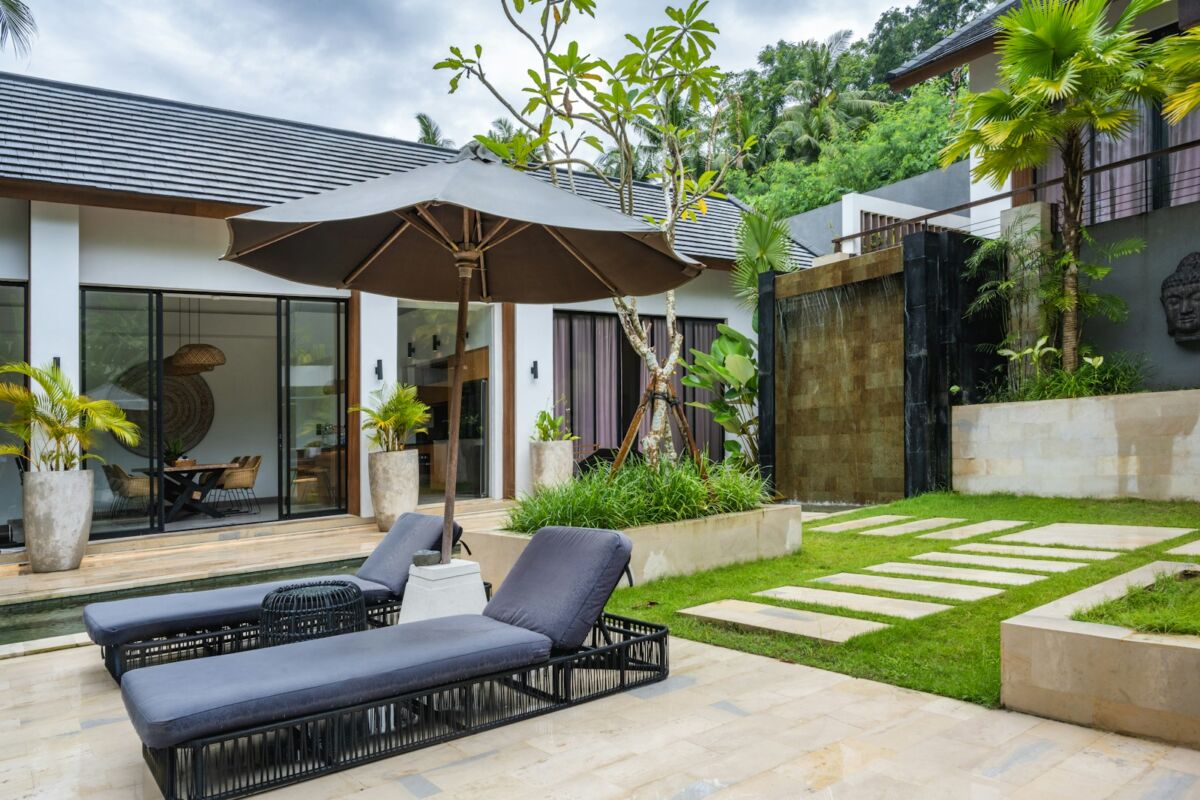 A patio with a lawn and a lounge chair, Modern Backyard Ideas