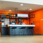 An orange and blue room with bar stools, Orange Kitchen Ideas