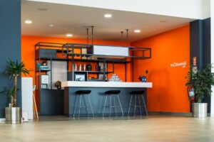 An orange and blue room with bar stools, Orange Kitchen Ideas