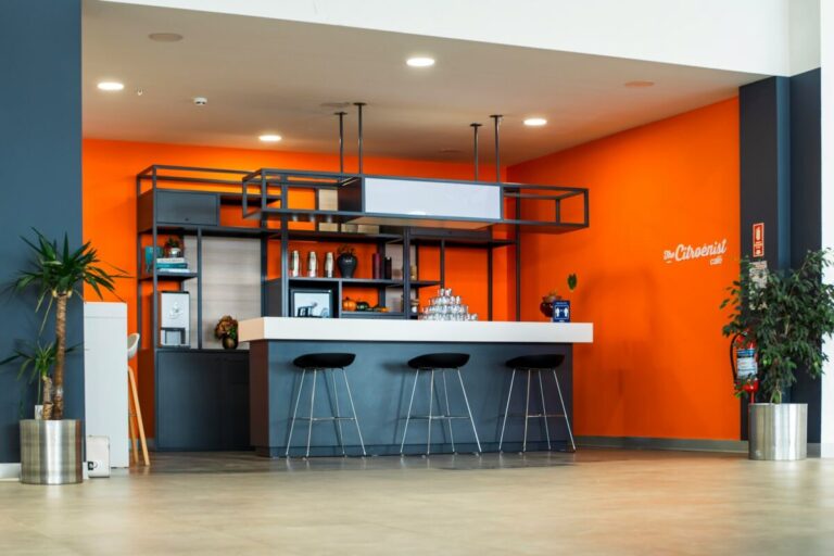An orange and blue room with bar stools, Orange Kitchen Ideas