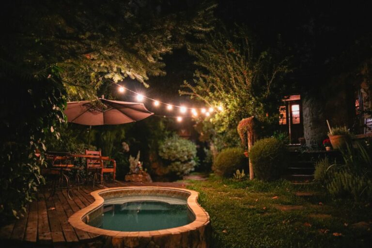 a hot tub in the middle of a garden at night, Outdoor Lighting Ideas