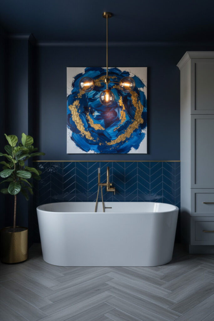 Moody navy space with glossy geometric backsplash, brass chandelier, and abstract art—dramatic modern blue bathroom decor.