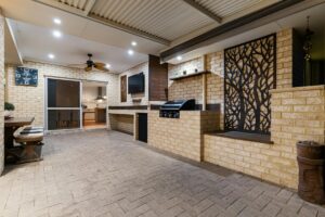 A room with a brick wall and a ceiling fan