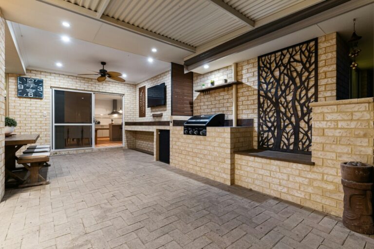A room with a brick wall and a ceiling fan