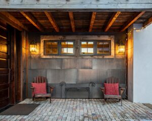 a couple of chairs sitting on top of a brick floor