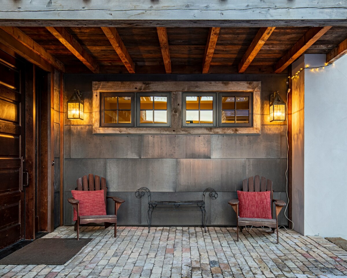 a couple of chairs sitting on top of a brick floor